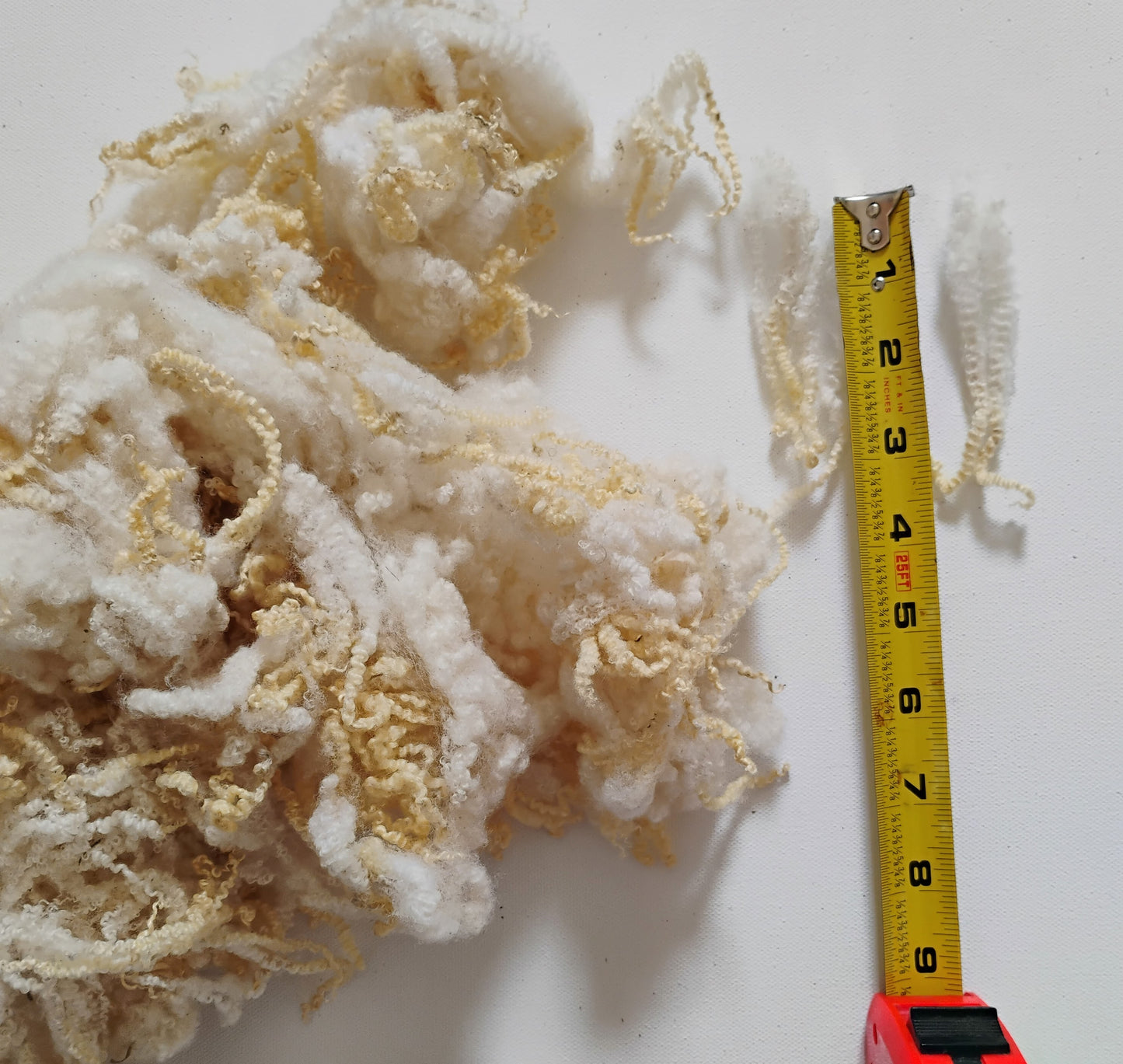BFL Locks sold by .50 ounce (1.5 ounce in pic) - Creamy white/honey tips 3 1/2" +/-. Tiny crimp, arts/crafts, needle felt, doll hair,